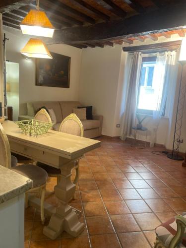 a living room with a table and a couch at Pietre Antiche Loft in Manciano