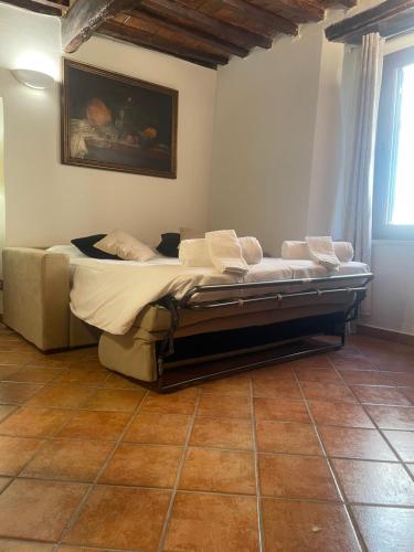a bed in a room with a painting on the wall at Pietre Antiche Loft in Manciano