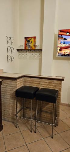 two stools sitting at a bar in a room at Casa Stefano in Casperia