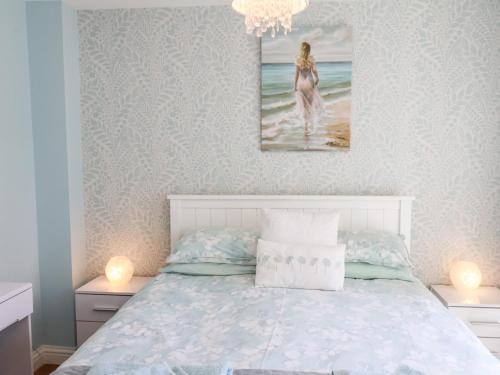 a bedroom with a bed and a painting on the wall at Denby Escape in Filey