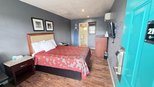 a hotel room with a bed and a television at Fireside Inn By The Beach Boardwalk & Bowling in Santa Cruz