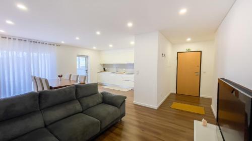 a living room with a couch and a table at Nico Home in Ponta Delgada
