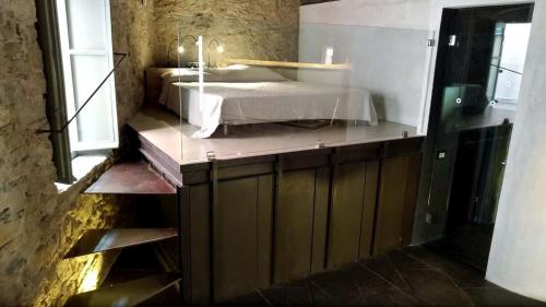 a bedroom with a bed in a room with a window at AgriIlGeco II - Casa BDonne - by HOST4U in Civezza
