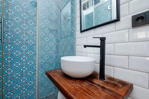 a white sink on a wooden table in a bathroom at Exclusive House with 2 Apartments including 4 Bedrooms and 4 Bathrooms in Total in Istanbul