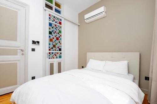 a white bedroom with a white bed and a window at Exclusive House with 2 Apartments including 4 Bedrooms and 4 Bathrooms in Total in Istanbul