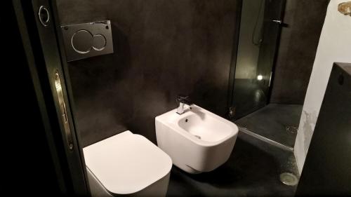 a bathroom with a toilet and a sink and a shower at AgriIlGeco III - Casa a Volte - by HOST4U in Civezza