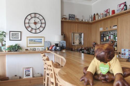 a stuffed bear sitting on the counter of a bar at Bryn-Y-Mor Hotel in Llandudno