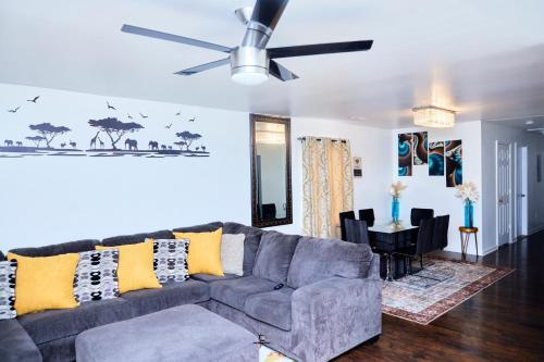 a living room with a couch and a ceiling fan at Beautifully Designed & Spacious Apartment in Newark 10mins from EWR Airport, Close to NYC and Beth Israel Hospital in Newark