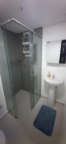 a bathroom with a glass shower and a sink at Medellín Apartment Loft in Medellín