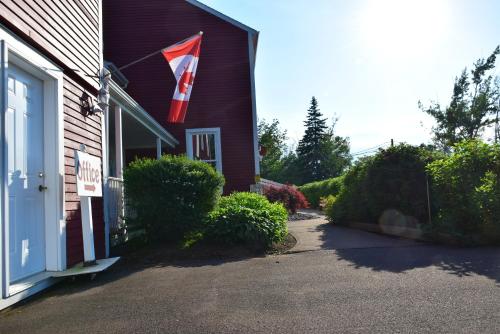 a flag on the side of a house at Auberge Wild Rose Inn in Moncton