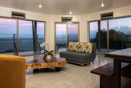 a living room with a chair and a table at Lake Arenal Condos in Naranjos Agrios