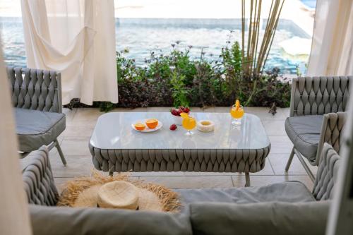 a table with fruit and drinks on top of a patio at Villa Myria, 3BD, Private Pool, Garden, BBQ, Near the Beach in Kisonerga in Paphos