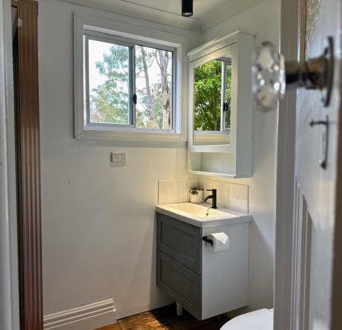 a bathroom with a sink and a window at Kookaburra Retreat in Daylesford