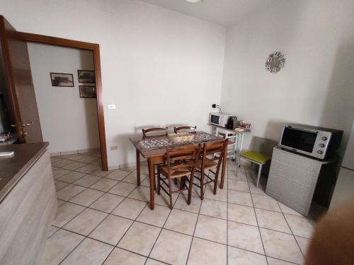 a kitchen with a table and chairs in a room at Corte Lavito in Tuglie