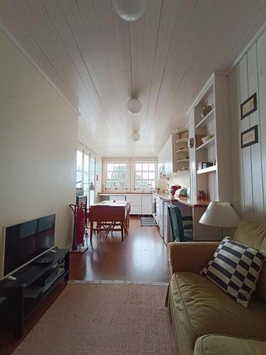 a living room with a couch and a table at Casa dos Narizes in Angra do Heroísmo
