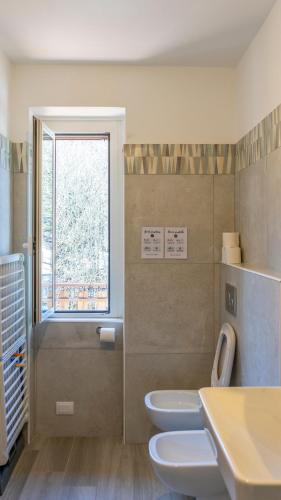 a bathroom with two toilets and a window at Bellagio, Como Lake Tivano - Lago di Como in Bellagio
