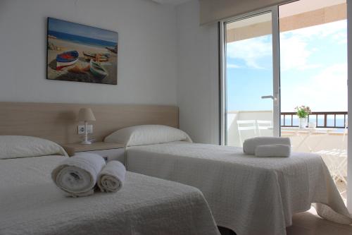 A bed or beds in a room at Apartamento Quesada