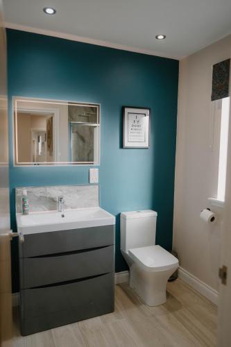a bathroom with a white sink and a toilet at Stanloch Barn - new barn conversion, well equipped, EV in Glencaple