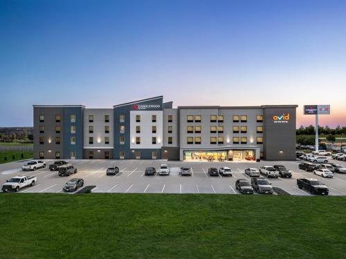 a large building with cars parked in a parking lot at avid hotel North Platte by IHG in North Platte