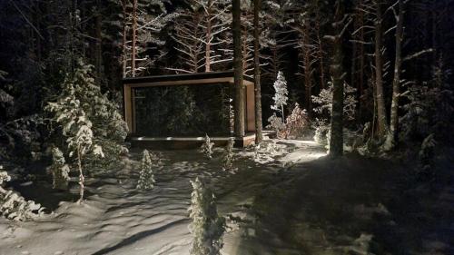 a painting of a forest with a gate in the snow at Mooni Minivilla in Haversi