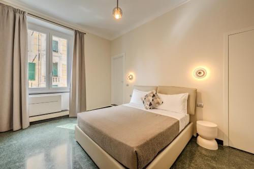 a bedroom with a bed and a window at The Bliss Apartments in Genova