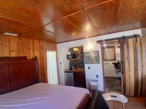Un dormitorio con una cama y un techo de madera. en Boulder Bay Cottages, en Big Bear Lake