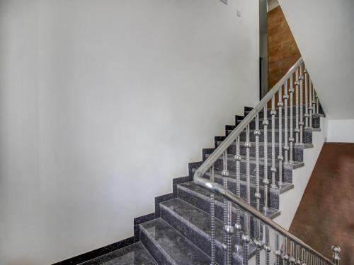 a staircase in a house with a metal railing at Hotel O Muktesh Chandra in Goa