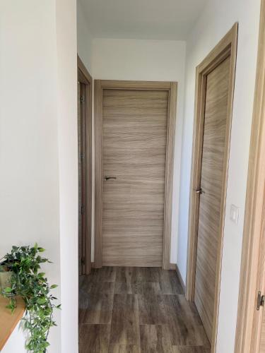 a hallway with a wooden door in a house at Villa Ikigai Costa in Villaviciosa