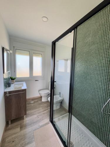 a bathroom with a shower and a sink and a toilet at Villa Ikigai Costa in Villaviciosa