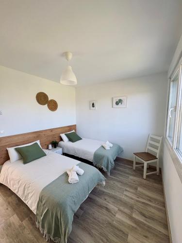 a room with two beds and a window at Villa Ikigai Costa in Villaviciosa