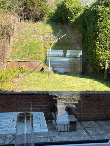 a view of a yard from a glass window at Dumbarton With A View in Dumbarton