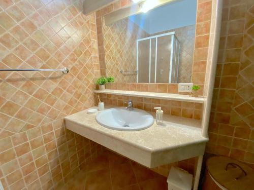 a bathroom with a sink and a mirror at Sos Alinos - Cala Liberotto - Orosei - Apartment 4 in Cala Liberotto