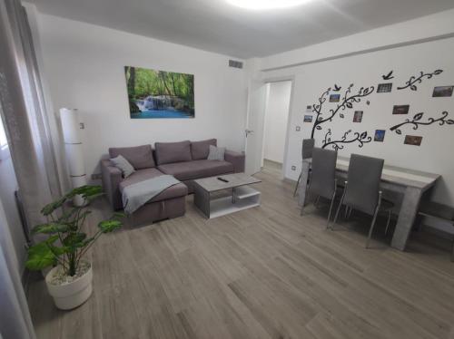 a living room with a couch and a table at Apartamento con Jacuzzi El Rincón de las Delicias in Zaragoza