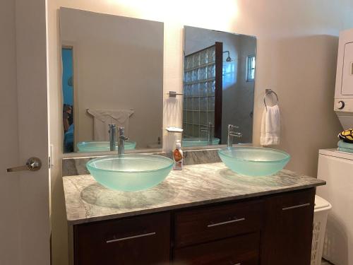 two sinks in a bathroom with a large mirror at Luxurious One Bedroom Poolside Punta Chame Resort in Pajonal