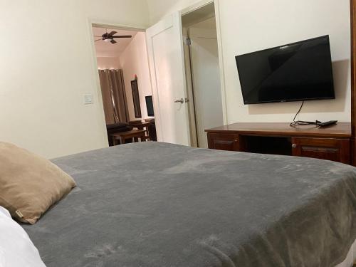 a bedroom with a large bed with a flat screen tv at Luxurious One Bedroom Poolside Punta Chame Resort in Pajonal