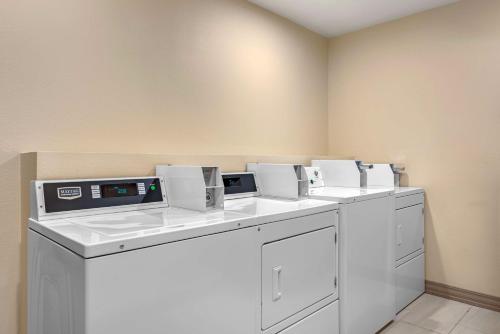 a laundry room with four washers and dryers at Best Western Executive Inn & Suites in Colorado Springs