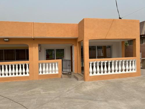 a building with a white fence in front of it at Cozy 2 bedroom apartment in Accra