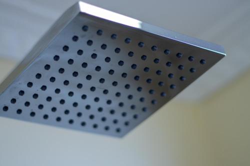 a metal shower grate on a ceiling at Karen Plains Hotel Nairobi in Nairobi