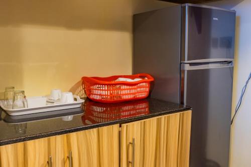 a red basket sitting on top of a kitchen counter at Karen Plains Hotel Nairobi in Nairobi