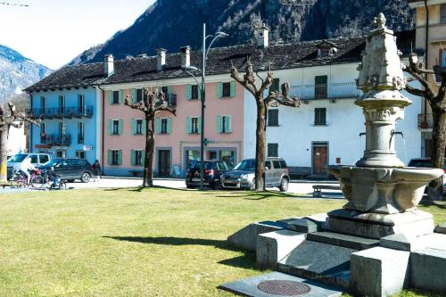 a statue in the middle of a park with buildings at Apartment in Vallemaggia Cevio in Cevio