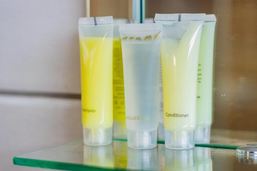 a group of four plastic containers filled with orange juice at Karen Plains Hotel Nairobi in Nairobi