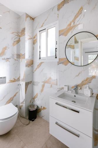 a bathroom with a white sink and a mirror at Villa Myria, 3BD, Private Pool, Garden, BBQ, Near the Beach in Kisonerga in Paphos