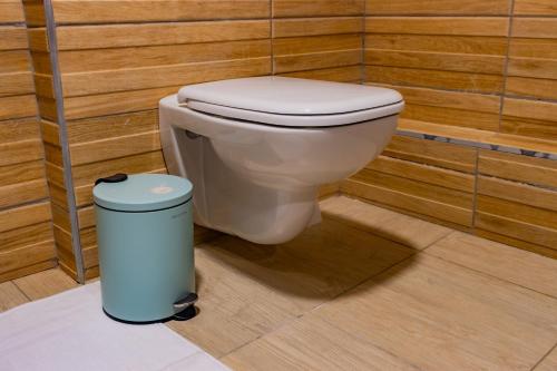 a bathroom with a toilet and a trash can at Karen Plains Hotel Nairobi in Nairobi