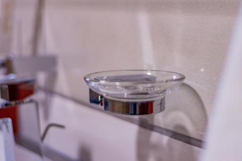 a glass bowl on a shelf in a room at Karen Plains Hotel Nairobi in Nairobi