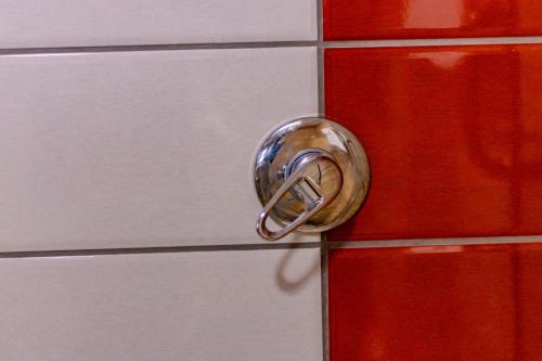 a metal door knob on a red and white cabinet at Karen Plains Hotel Nairobi in Nairobi