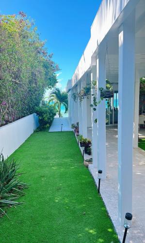 a green lawn in front of a building at Ocean Garden Studio II in Rat Island