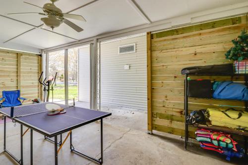 a room with a table and a ceiling fan at Potomac River Getaway Walk to Marina! in King George