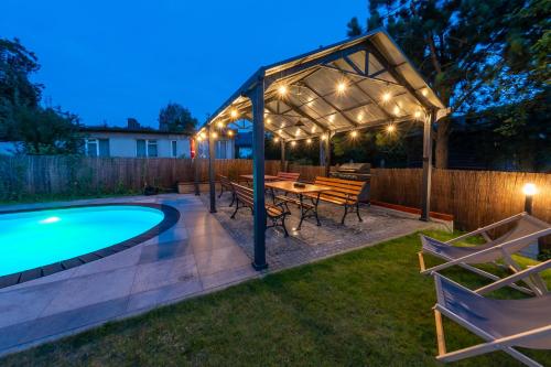a backyard with a pergola and a swimming pool at Willowa 21 in Wisła