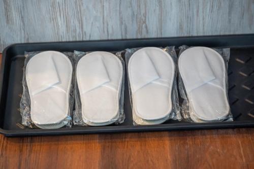 three pairs of shoes in a tray on a table at Willowa 21 in Wisła