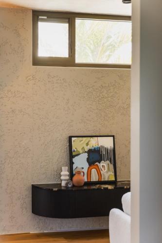 a living room with a table and a window at NACRE curated luxury - steps to the beach - heated pool in Marcoola